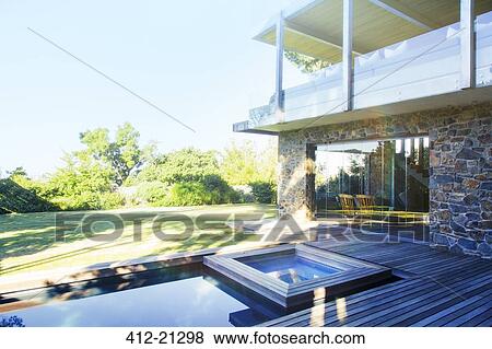 Modern house overlooking pool and wooden deck View Large Photo Image Stock Photo - Modern house overlooking pool and wooden deck. Fotosearch