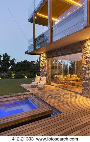 Modern house overlooking swimming pool and wooden deck View Large Photo Image Stock Image - Modern house overlooking swimming pool and wooden deck. Fotosearch