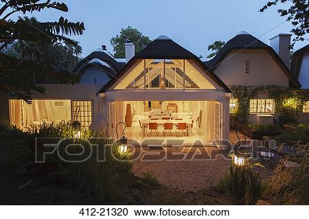 Open modern house illuminated at night View Large Photo Image Stock Image - Open modern house illuminated at night. Fotosearch
