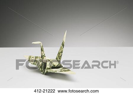 Origami Crane Made Of Dollar Bill On Counter Stock Image