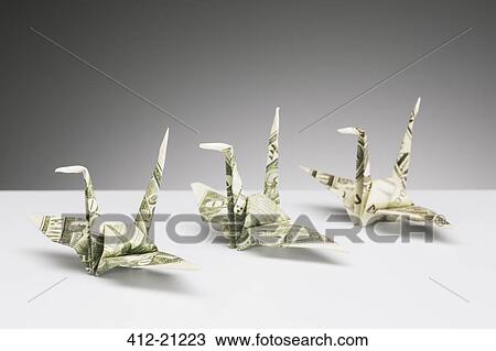 Origami cranes made of dollar bills on counter View Large Photo Image Stock Image - Origami cranes made of dollar bills on counter. Fotosearch