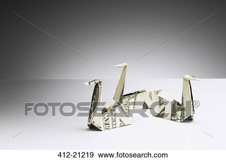 Origami swans made of dollar bills on counter View Large Photo Image Stock Photo - Origami swans made of dollar bills on counter. Fotosearch