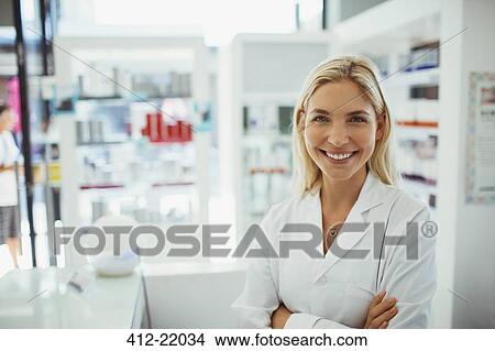 Pharmacist smiling in drugstore View Large Photo Image Picture - Pharmacist smiling in drugstore. Fotosearch