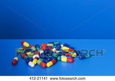 Pile of prescription pills on blue counter View Large Photo Image Stock Image - Pile of prescription pills on blue counter. Fotosearch