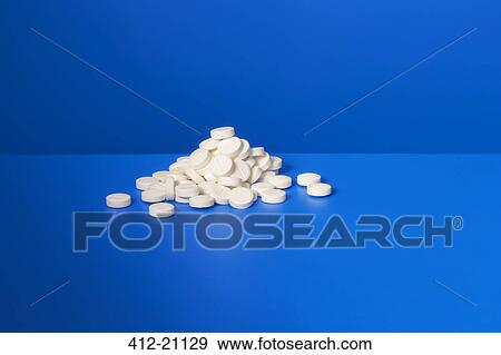 Pile of prescription pills on blue counter View Large Photo Image Stock Photo - Pile of prescription pills on blue counter. Fotosearch