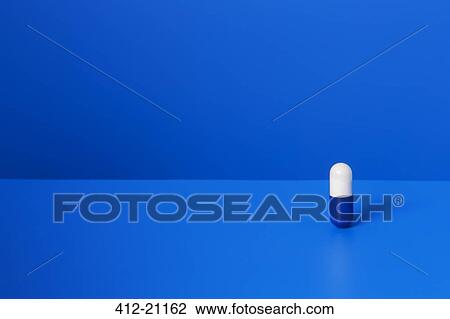 Prescription pill standing upright on blue counter View Large Photo Image Stock Image - Prescription pill standing upright on blue counter. Fotosearch