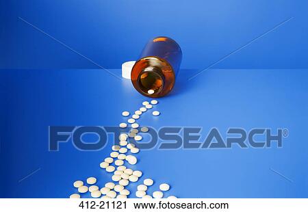 Prescription pills spilling out of bottle onto blue counter View Large Photo Image Stock Image - Prescription pills spilling out of bottle onto blue counter. Fotosearch
