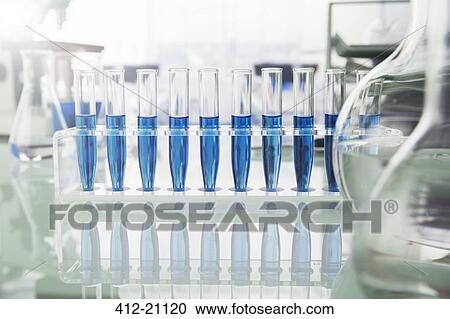 Stock Image - Rack of test tubes with solution on counter in lab. Fotosearch
