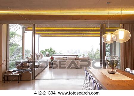 Sliding glass doors between open modern living and dining rooms View Large Photo Image Picture - Sliding glass doors between open modern living and dining rooms. Fotosearch