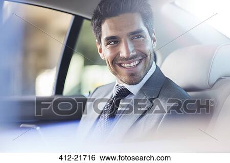 Stock Photograph - Smiling businessman sitting in car. Fotosearch