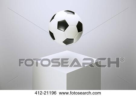Soccer ball hovering over pedestal View Large Photo Image Stock Photograph - Soccer ball hovering over pedestal. Fotosearch