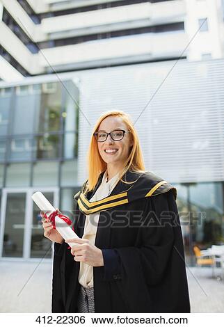 Student in cap and gown holding scroll View Large Photo Image Stock Photograph - Student in cap and gown holding scroll . Fotosearch