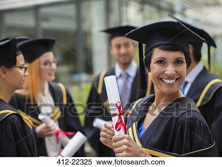 Stock Photography - Student in cap and gown smiling with colleges. Fotosearch