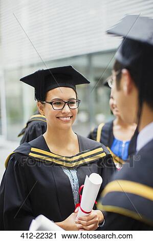 Student in cap and gown talking with friends View Large Photo Image Stock Image - Student in cap and gown talking with friends. Fotosearch
