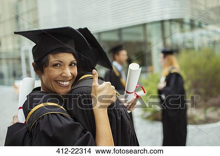Students in cap and gown hugging View Large Photo Image Picture - Students in cap and gown hugging. Fotosearch