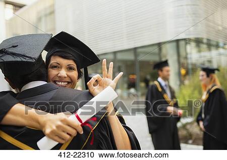Students in cap and gown hugging View Large Photo Image Stock Image - Students in cap and gown hugging. Fotosearch