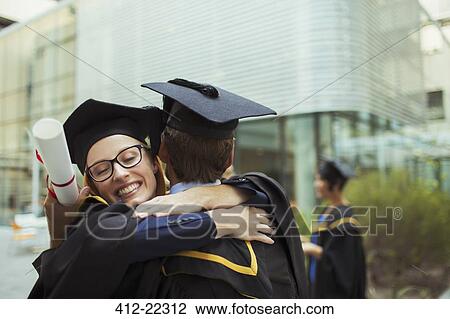 Students in cap and gown hugging View Large Photo Image Stock Image - Students in cap and gown hugging. Fotosearch