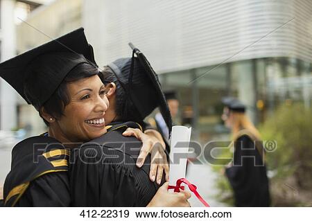 Students in cap and gown hugging View Large Photo Image Stock Photo - Students in cap and gown hugging. Fotosearch