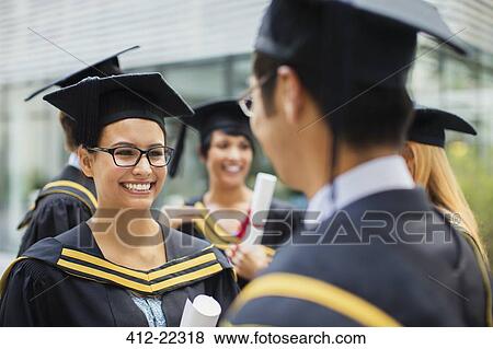 Students in cap and gown talking View Large Photo Image Stock Photo - Students in cap and gown talking. Fotosearch