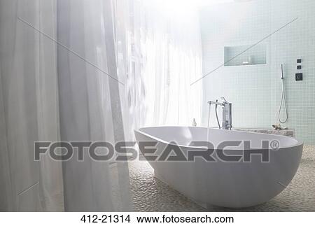 Water pouring into bathtub in modern bathroom View Large Photo Image Picture - Water pouring into bathtub in modern bathroom. Fotosearch