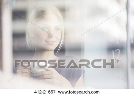 Woman drinking coffee indoors View Large Photo Image Stock Photo - Woman drinking coffee indoors. Fotosearch