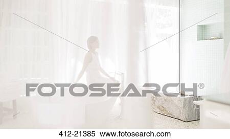 Woman in modern bathroom viewed through sheer curtain View Large Photo Image Stock Photography - Woman in modern bathroom viewed through sheer curtain. Fotosearch