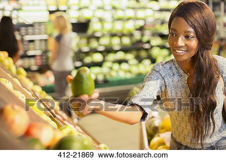 Woman shopping for fruit in grocery store View Large Photo Image Stock Photo - Woman shopping for fruit in grocery store. Fotosearch