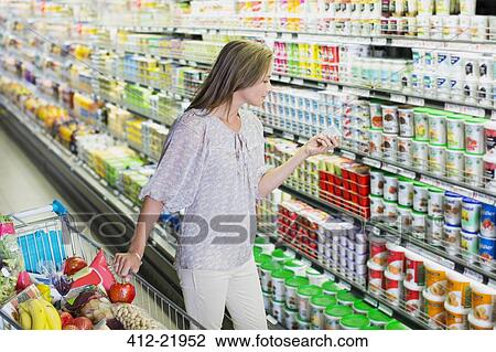 Woman shopping in grocery store View Large Photo Image Stock Image - Woman shopping in grocery store. Fotosearch