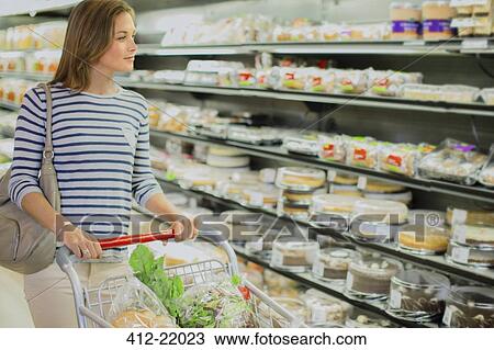 Woman shopping in grocery store View Large Photo Image Stock Image - Woman shopping in grocery store. Fotosearch