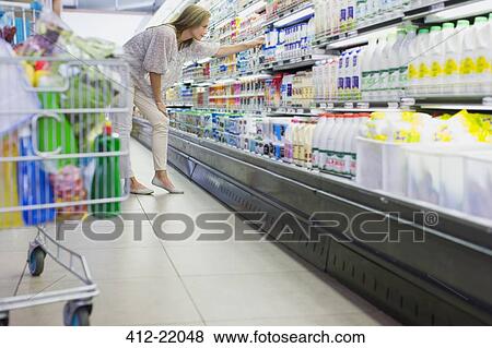 Woman shopping in grocery store View Large Photo Image Stock Photo - Woman shopping in grocery store. Fotosearch