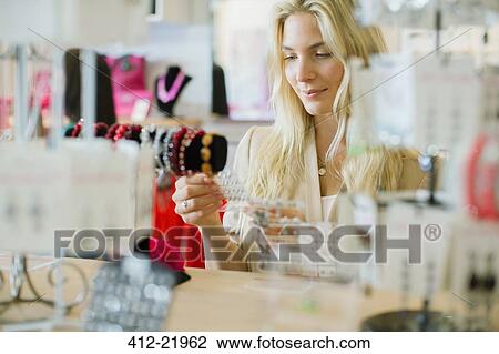 Woman shopping in store View Large Photo Image Stock Image - Woman shopping in store. Fotosearch
