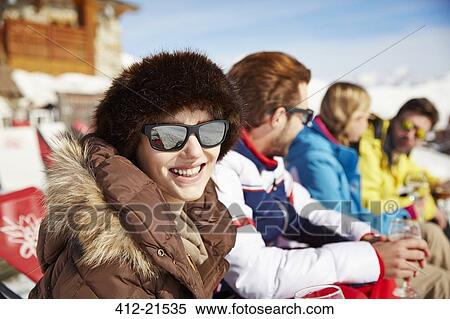Woman sitting with friends in snow View Large Photo Image Stock Photography - Woman sitting with friends in snow. Fotosearch
