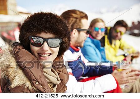 Woman sitting with friends in the snow View Large Photo Image Stock Photography - Woman sitting with friends in the snow. Fotosearch