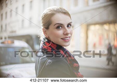 Woman smiling on city street View Large Photo Image Stock Photo - Woman smiling on city street . Fotosearch