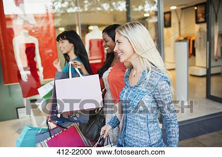 Women carrying shopping bags in shopping mall View Large Photo Image Stock Image - Women carrying shopping bags in shopping mall. Fotosearch