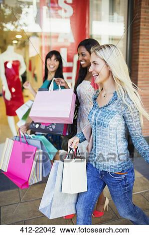 Women carrying shopping bags in shopping mall View Large Photo Image Stock Image - Women carrying shopping bags in shopping mall. Fotosearch