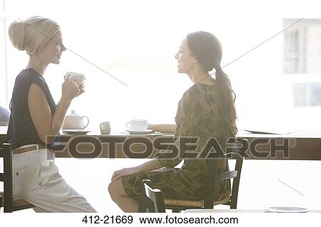 Women having coffee together at cafe View Large Photo Image Stock Photo - Women having coffee together at cafe . Fotosearch