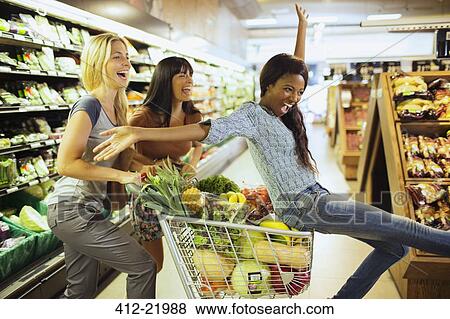 Women playing together in grocery store View Large Photo Image Stock Photo - Women playing together in grocery store. Fotosearch