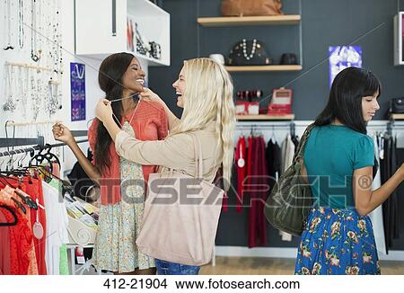 Picture - Women shopping together in clothing store. Fotosearch