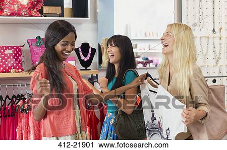 Women shopping together in clothing store View Large Photo Image Stock Image - Women shopping together in clothing store. Fotosearch