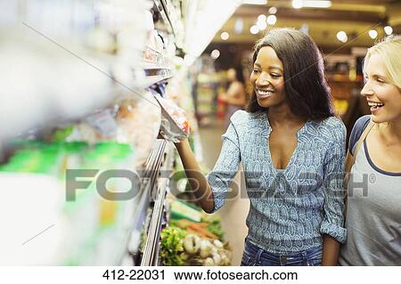 Women shopping together in grocery store View Large Photo Image Stock Image - Women shopping together in grocery store. Fotosearch
