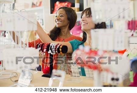 Stock Photo - Women shopping together in store. Fotosearch