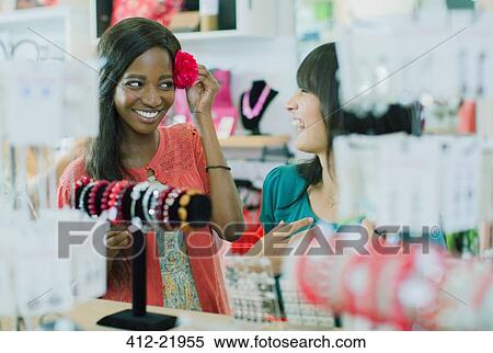 Stock Photography - Women shopping together in store. Fotosearch