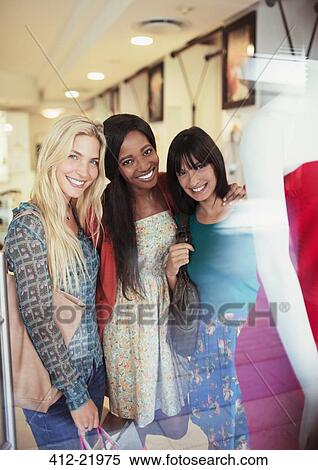 Women smiling together in clothing store View Large Photo Image Stock Photography - Women smiling together in clothing store. Fotosearch