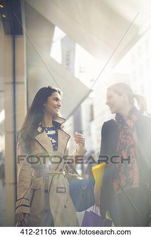 Stock Photography - Women walking down city street together. Fotosearch