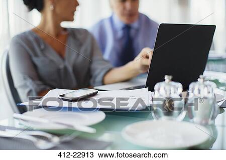 Stock Image - Business woman pointing to laptop screen . Fotosearch