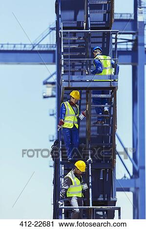 Businessman and workers climbing stairs on cargo crane View Large Photo Image Stock Image - Businessman and workers climbing stairs on cargo crane. Fotosearch