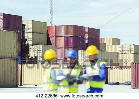 Businessman and workers talking near cargo containers View Large Photo Image Stock Photograph - Businessman and workers talking near cargo containers. Fotosearch