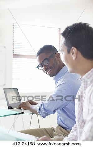 Businessmen working with laptop in office View Large Photo Image Stock Photo - Businessmen working with laptop in office. Fotosearch