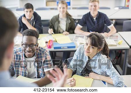 Cheerful High School students sitting in classroom View Large Photo Image Picture - Cheerful High School students sitting in classroom. Fotosearch